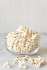Popcorn in a bowl on grey background
