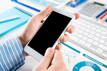 businessman with a smartphone, works in the office