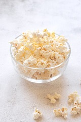Popcorn in a bowl on grey background