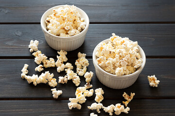 Popcorn in two bowls on a dark background