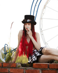 Glamorous girl with scarlet dreadlocks and cigarette