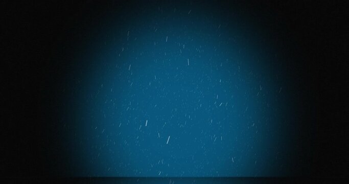 Animation of snow falling in spotlight on blue background