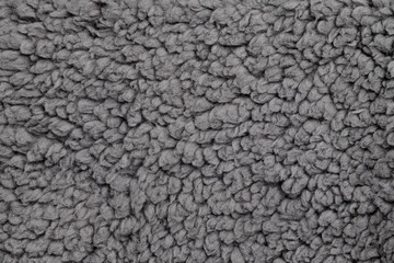 Texture of gray faux fur, close up. Texture of fashionable fur fabric.