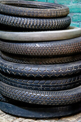 Pile of old vintage tyres inside a vintage old dusty workshop