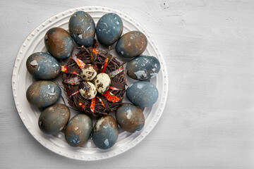 Painted chicken and quail eggs on a white platter