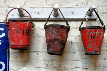 Three red fire buckets in an workshop in Beamish Village © adfoto