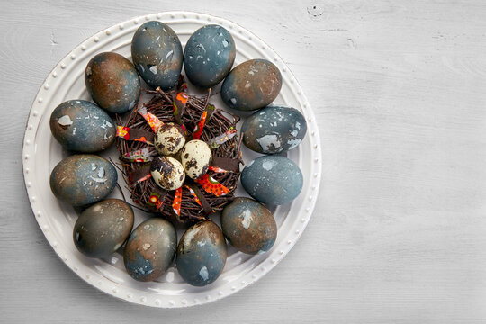 Painted chicken and quail eggs on a white platter