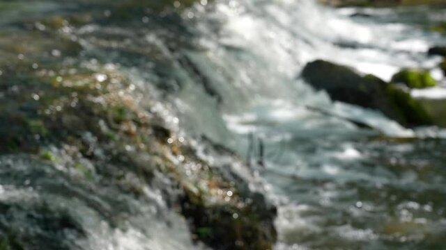 4k stock video footage of beautiful sunny blurry defocused rocky river flowing outside in forest. Europe, Ukraine
