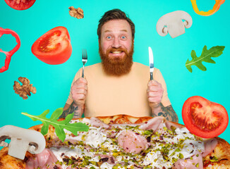 Man with beard and tattoos is ready to eat a big pizza