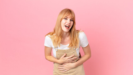 pretty red head woman laughing out loud at some hilarious joke