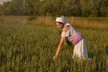 a girl in a field at sunset