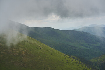 Low clouds and fog over the mountains. Svidovets ridge. Ukraine, Carpathian mountains.