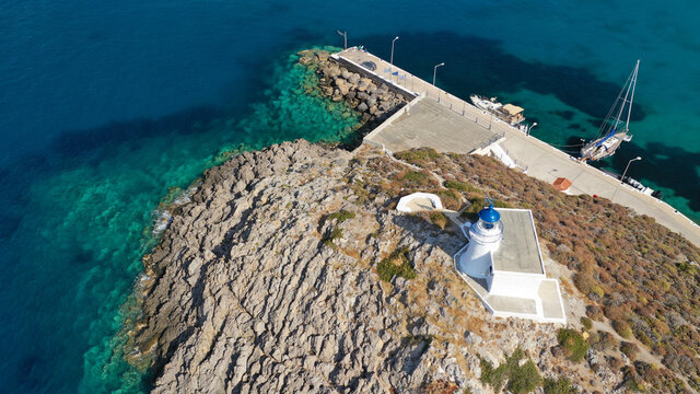 Aerial drone photo of iconic lighthouse in the entrance of small port in beautiful Kapsali bay and beach, Kythira island, Ionian, Greece