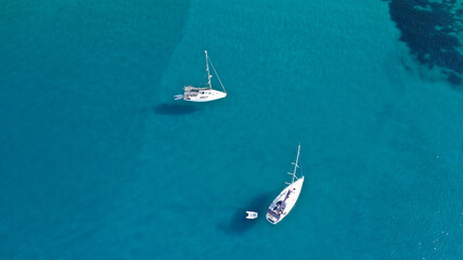 Aerial drone photo of catamaran sailing yacht anchored in tropical exotic emerald sea coral reef bay