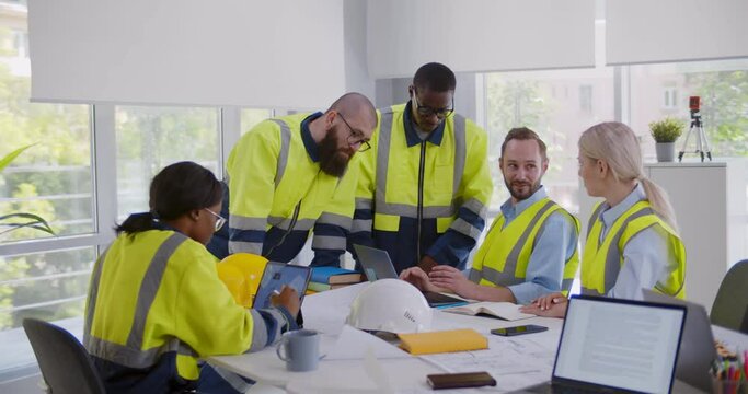 Multiracial engineers team meeting for architectural project in office