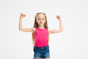 Half-length portrait of beautiful little girl in casual clothes posing isolated on white studio background. Happy childhood concept.