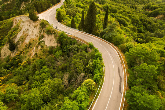 Beautiful idyllic summer landscape of Toscana with mediterranean plants, hills, trees, forests and fields. Sunny evening or morning in Italy. Vacation, recreation mood. Road in hills of Tuscany © boumenjapet