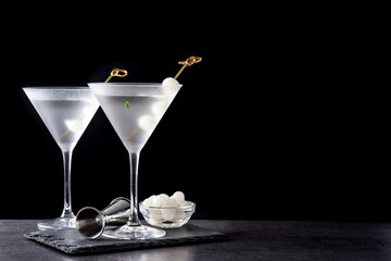Gibson martini cocktail with onions on black background. Copy space