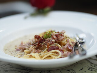 Spaghetti Carbonara with Unsmoked Bacon, Pancetta, Guanciale Heavy Cream, spaghetti alla carbonara food in white plate on the table