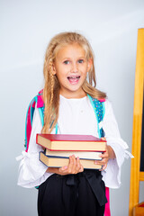 Child schoolgirl girl happy and beautiful on a white background, back to school