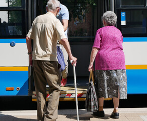 Old people are getting on the bus