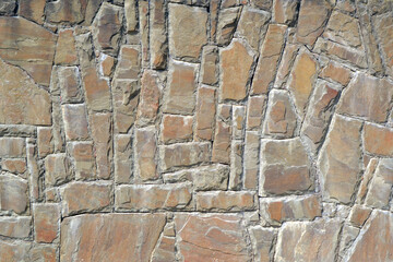 Texture of stone wall with mosaic tiles.