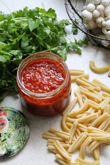 tomato puree in a jar, pasta, parsley, shimeji mushrooms, ingredients for a pasta dish