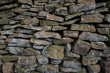 Dry stone wall background with textured rocks and stones.