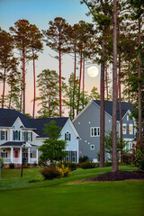 Full moon at sunset over beautiful suburban houses - 441393886