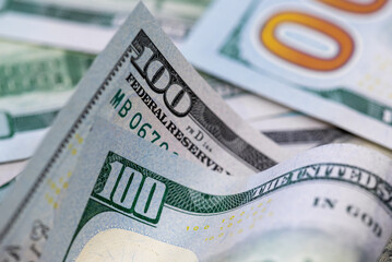 Obraz premium Close up of one hundred US dollar banknotes. Money background. Financial, business, investment and economical concept.