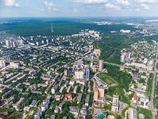 Naklejka premium Aerial view on green summer Kharkiv city center, Pavlovo pole and park. Botanical garden Sarzhyn Yar and multistory modern high residential buildings on bright sunny day