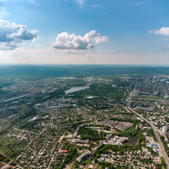 Obraz premium Aerial high view Kharkiv city Shevchenkivskyi district with Udy river, urban and residential multistory buildings with scenic colorful cloudy sky in summer