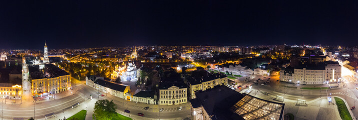 Obraz premium City center aerial wide panorama. Konstytutsii Square, historical museum, Sumska St, Cathedrals, Svyato-Pokrovskyy Monastyr landmarks in Kharkiv, Ukraine. Night lights illuminated