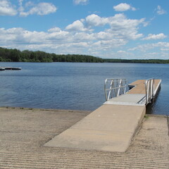 The wooden pier extends out over the lake.