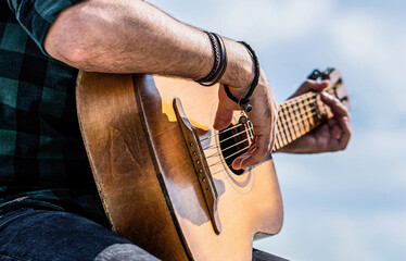 Man's hands playing acoustic guitar, close up. Acoustic guitars playing. Music concept. Guitars...
