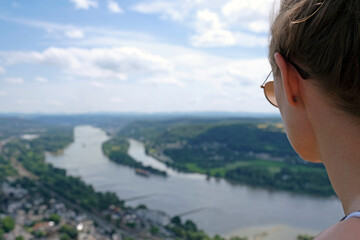 Fototapeta na wymiar Woman looking over the scenery with the river Rhine on a lookout