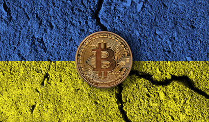 Bitcoin crypto currency coin with cracked Ukraine flag. Crypto restrictions