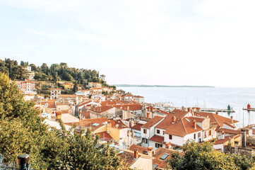 Fototapeta na wymiar A panoramic of old town Piran, Slovenia. View over the tiled roofs of Piran and the Adriatic Sea.