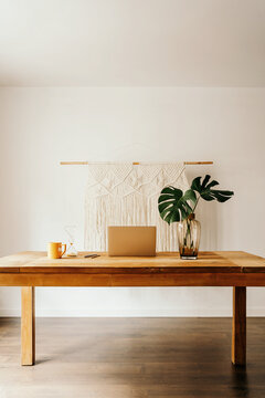 Gadgets and vase with plant on table