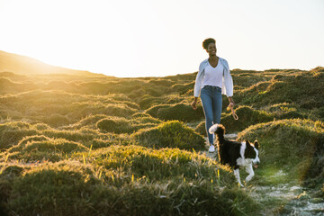 Woman with dog walking in nature