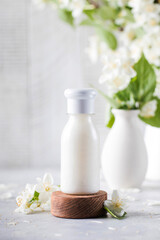 Obraz na płótnie Canvas Cosmetic detergent with jasmine extract. Mockup of cream, shampoo, soap.