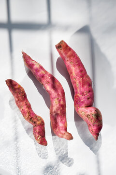 Raw sweet potato on table
