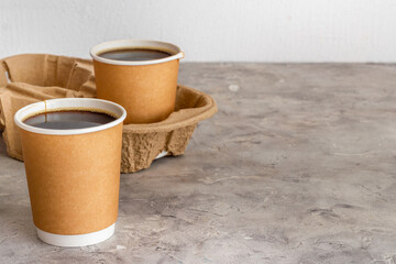 Take out coffee in paper cups on the table. Close up