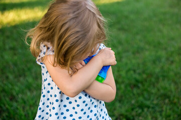 Fototapeta premium little girl playing in nature Push pop Bubble Pop it