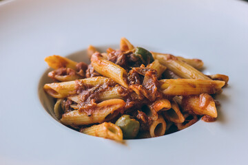 Pasta with tomato sauce, tuna and olives