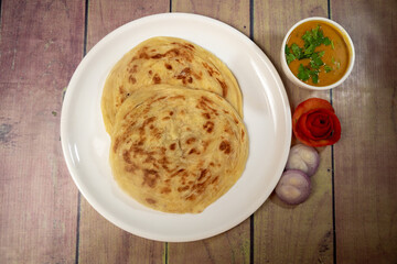 top view of maida parotta or paratha on a white plate