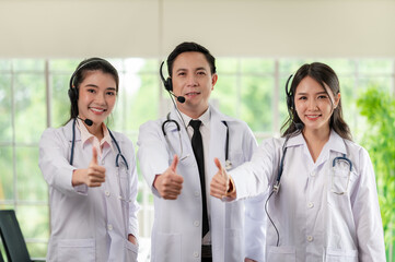 Asia medical service team health advice online. Smiling face stood wearing the headphones with a...