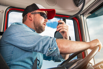 Truck Driver Taking Conversation Using CB Radio