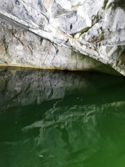 The wall of the grotto, reflected in the emerald water of the Marble Canyon in the Ruskeala Mountain Park.