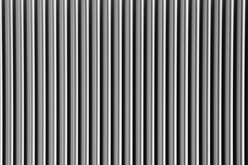 Obraz premium Abstract silver background with vertical lines, lit with a soft light.
